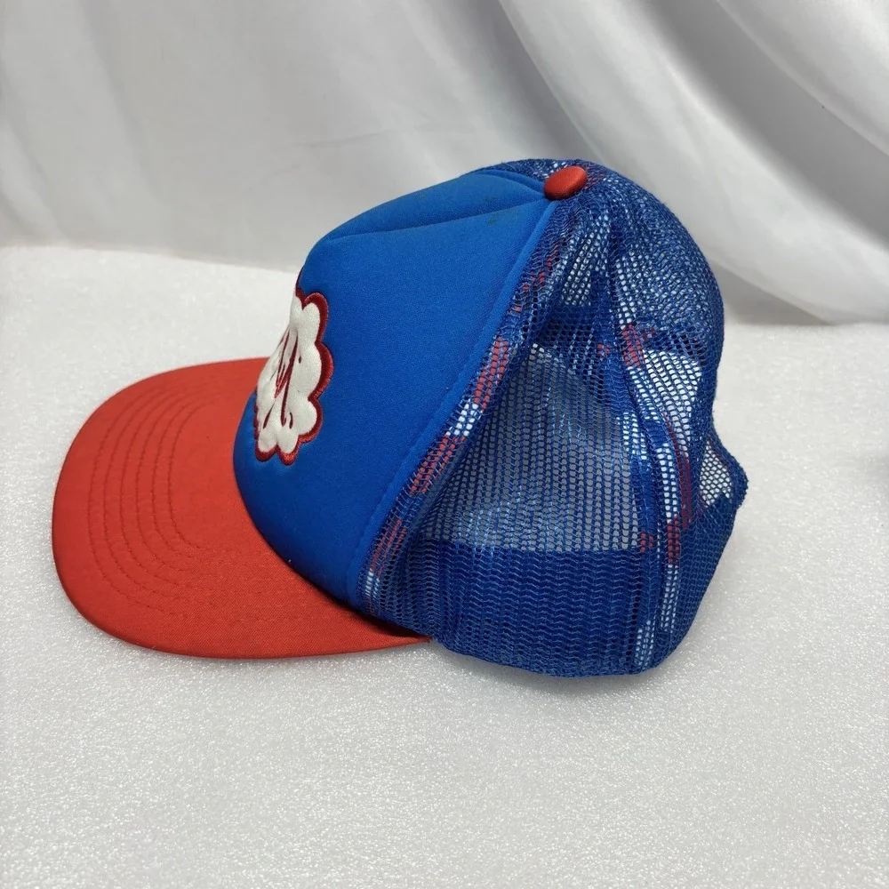 RVCA foam trucker hat featuring a blue crown, red brim, and red mesh back